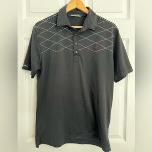Size medium Travis Mathew black Golf polo.  Geometric white stitching.